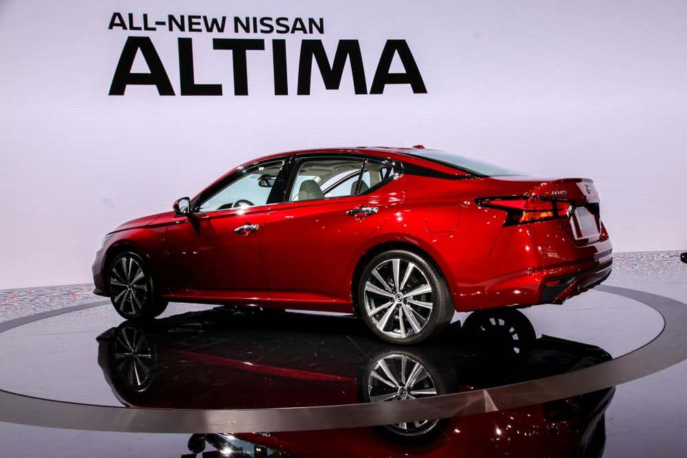 This is a red 2018 Nissan Altima on display at a car show.