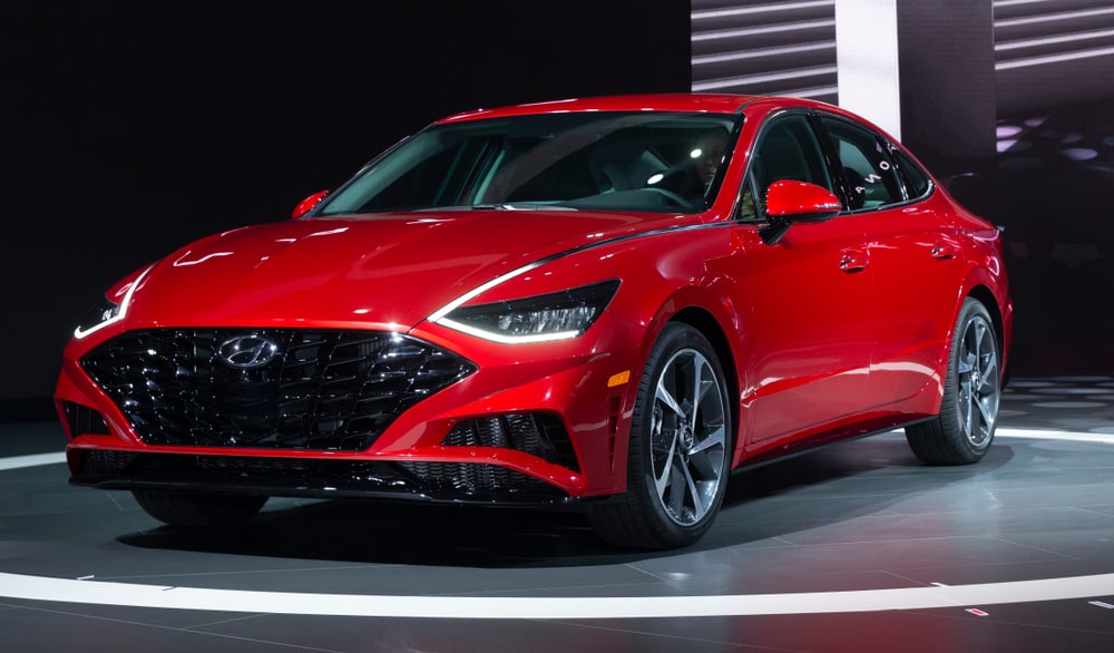 This is a red Hyundai Sonata on display at a car show.