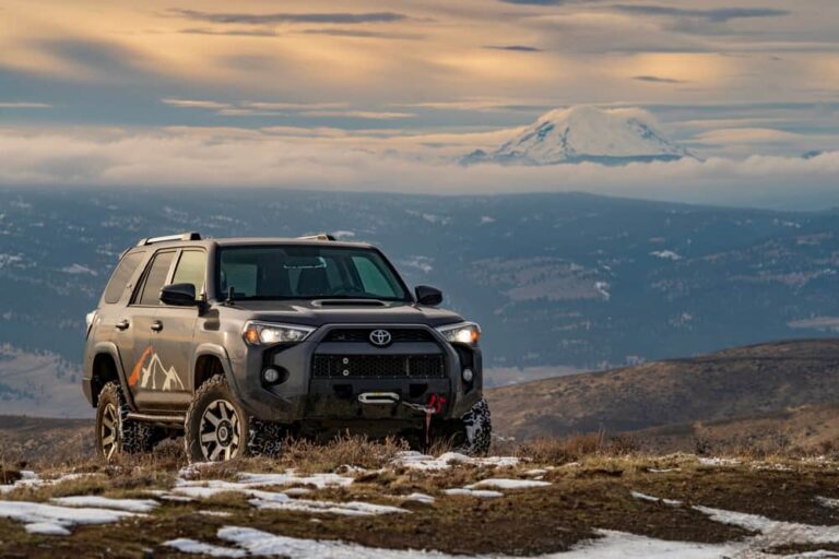 A black Toyota 4Runner on a rocky dirt mountain path.