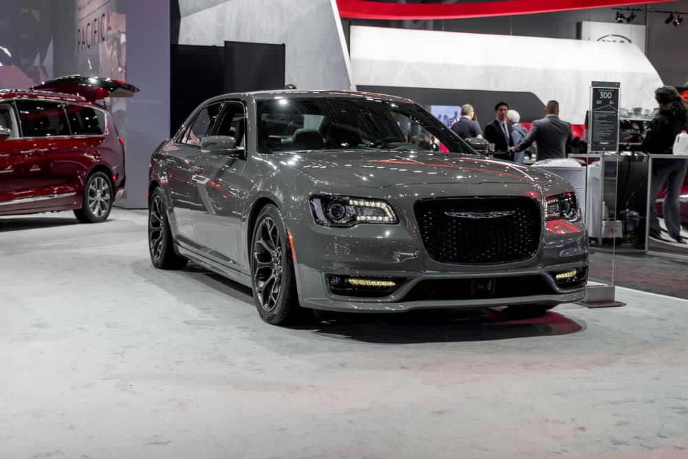 A gray Chrysler 300 on display at a car show.