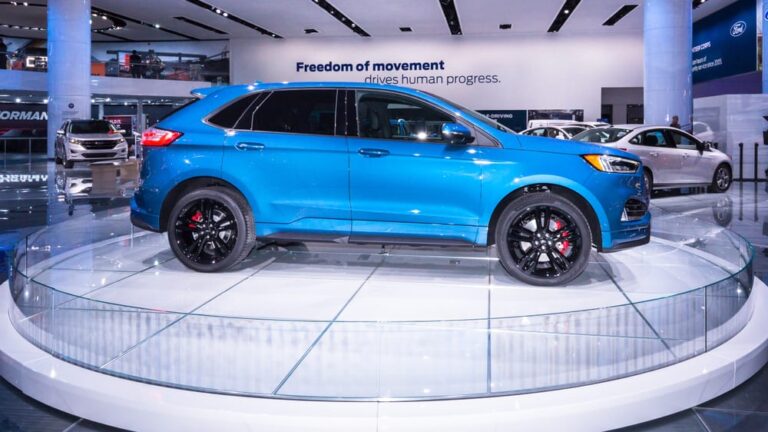 This is a blue Ford Edge on display at a car show.