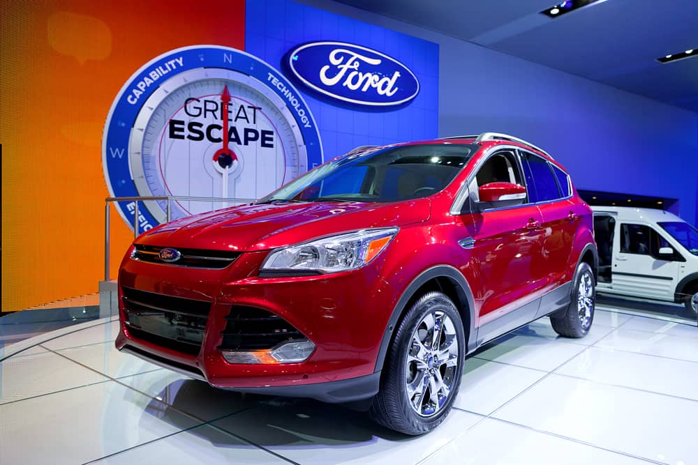 This is a red Ford Escape on display at a car show.