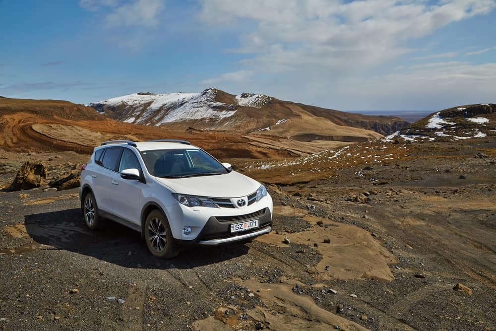 This is a white Toyota SUV on a rough mountain terrain.