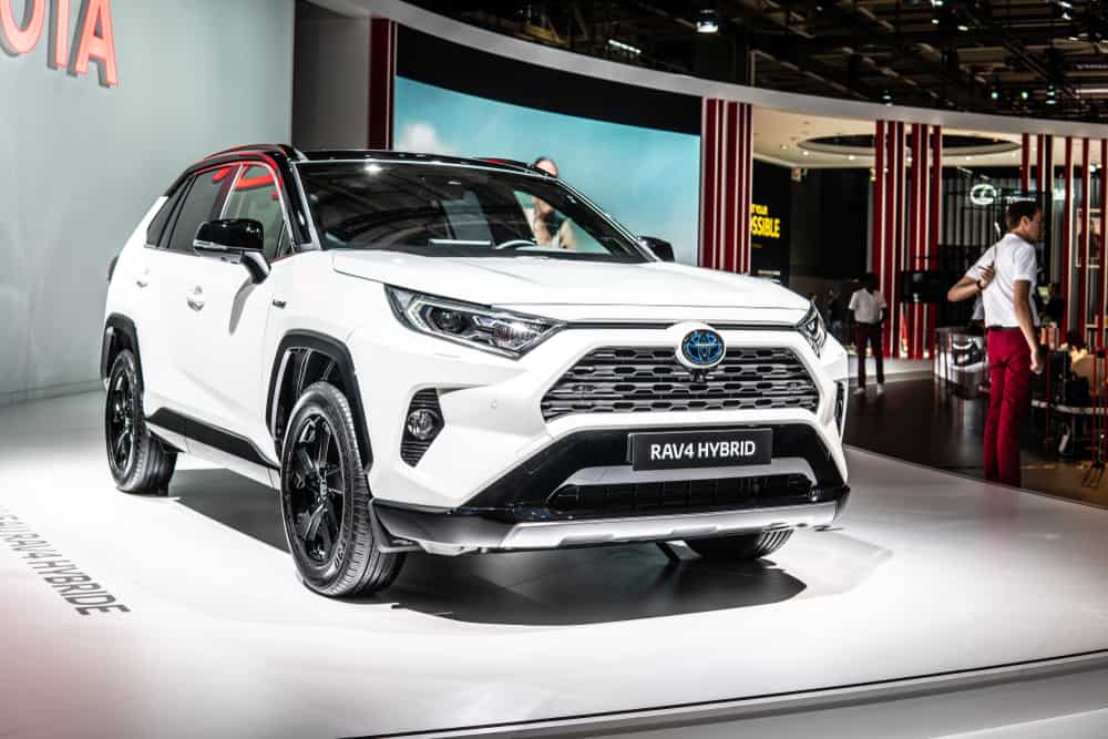 This is a white Toyota RAV4 on display at a car show.