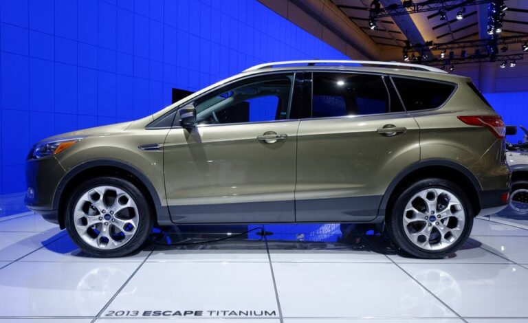 This is a gray Ford Escape on display at a car show.