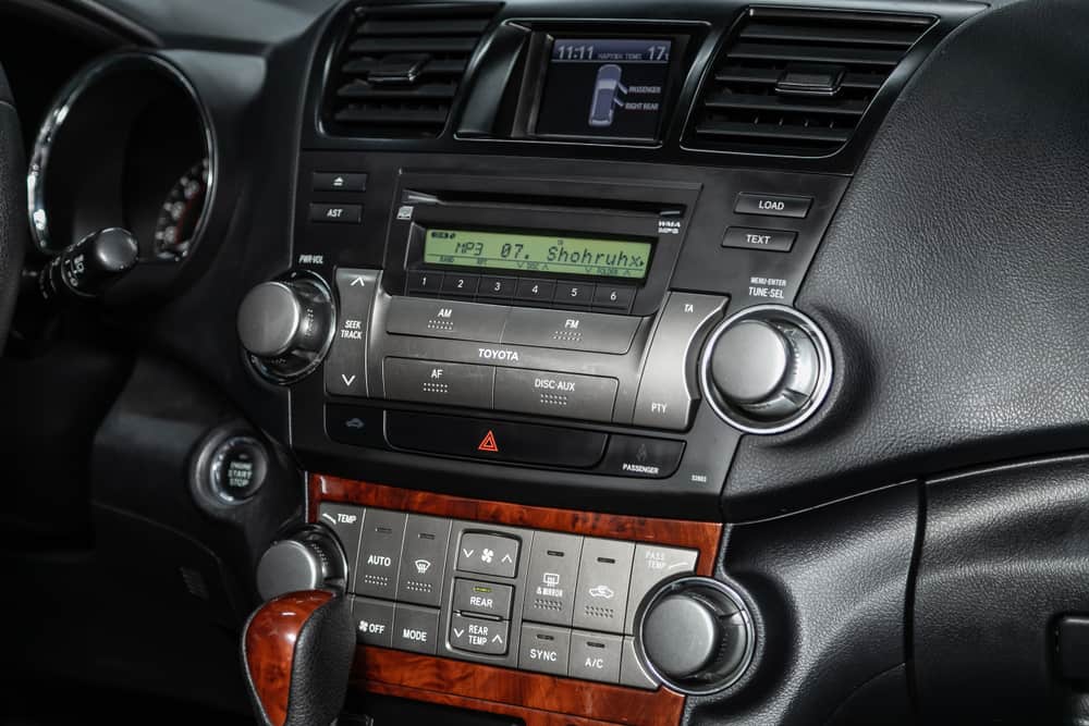 This is a close look at the dashboard infotainment center of the dashboard of a Toyota Highlander.