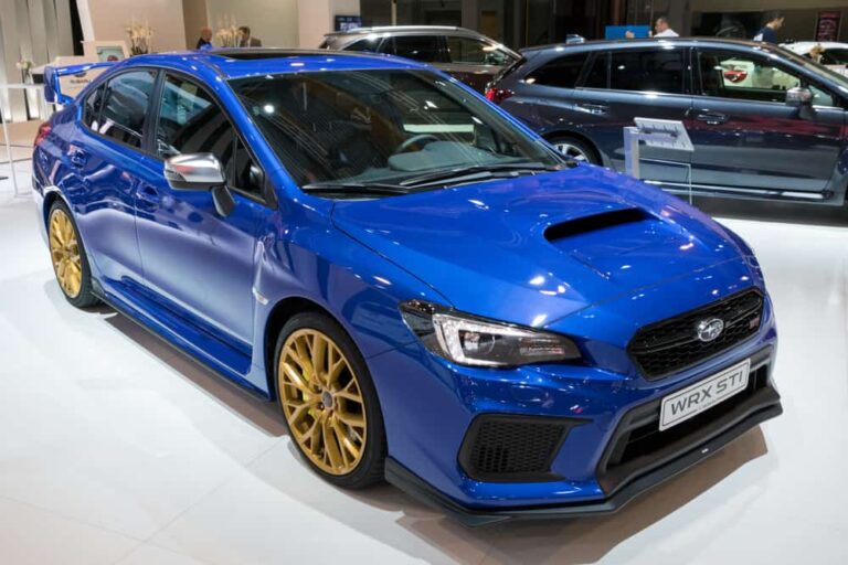 This is a blue Subaru WRX on display at a car show.