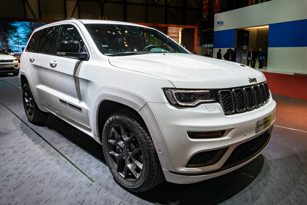 This is a white Jeep Grand Cherokee on display at a car show.