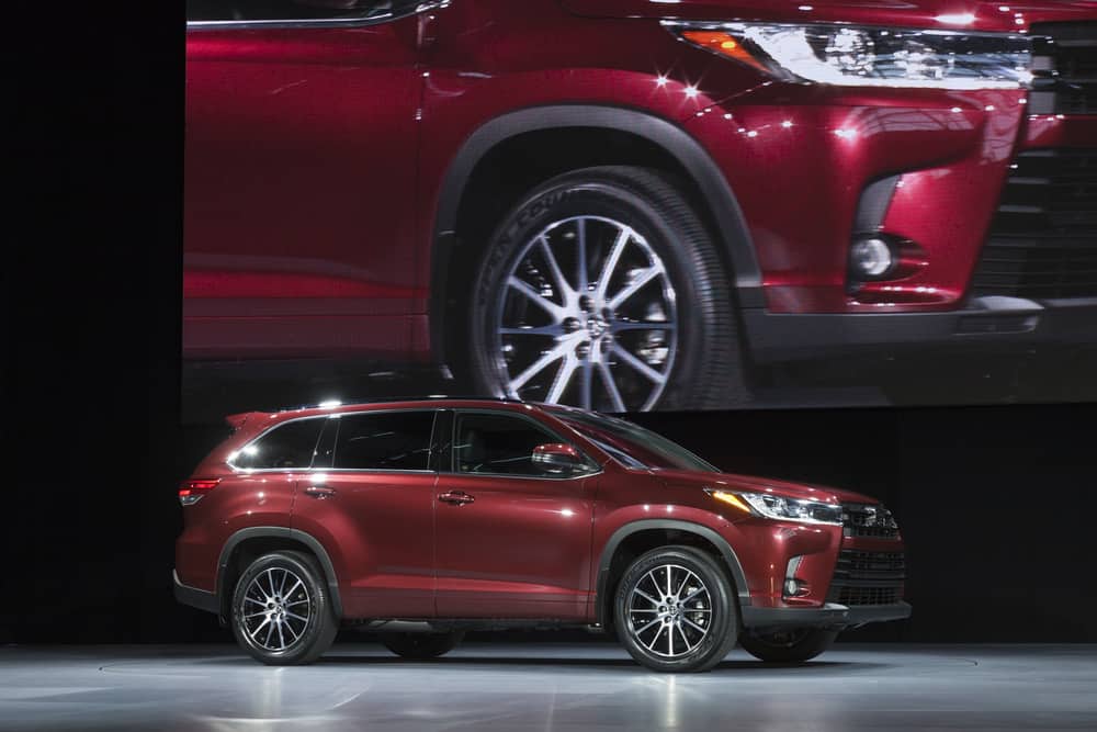 This is a red Toyota Highlander on display at a car show.