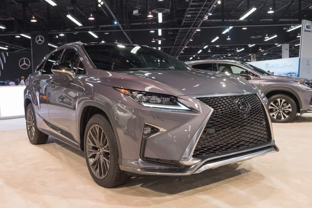 This is a gray Lexus RX on display at a car show.