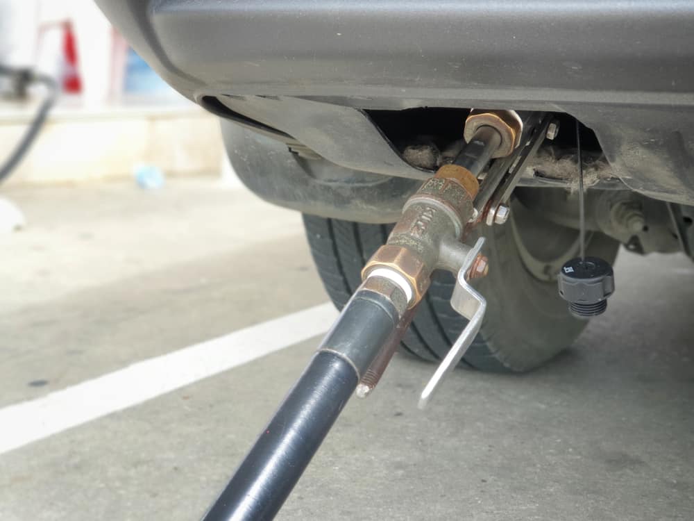 This is a close look at a Honda CR-V having its gas tank refilled in the gas station.