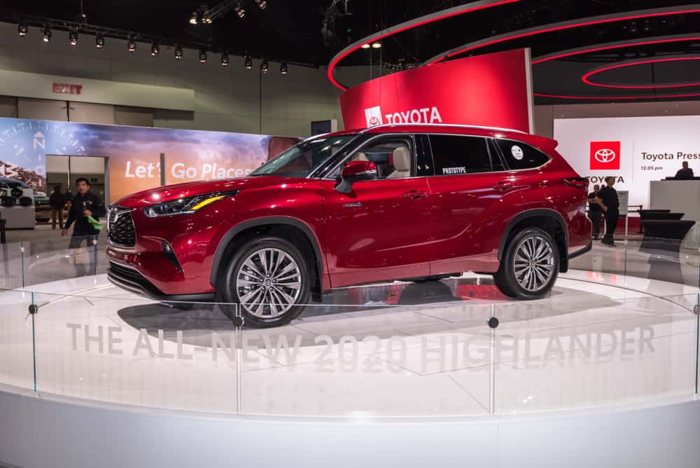 This is a red Toyota Highlander on display at a car show.