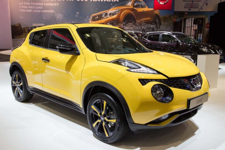 This is a yellow Nissan Juke on display at a car show.