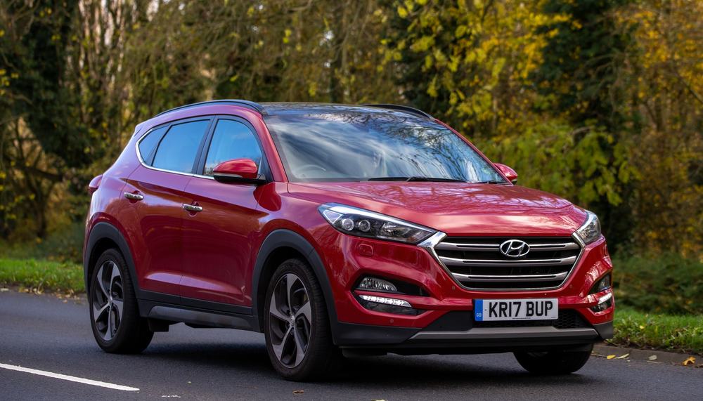 Red Hyundai Santa Fe on the street.