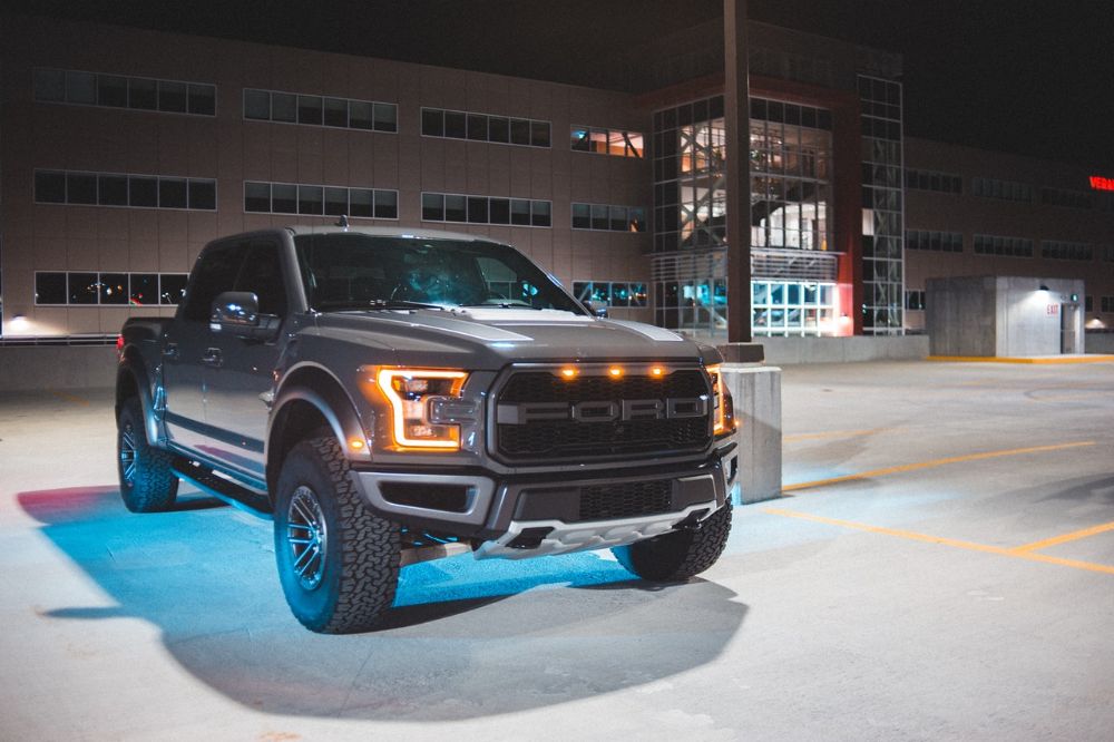 Black ford ranger pickup parking in an open space area.