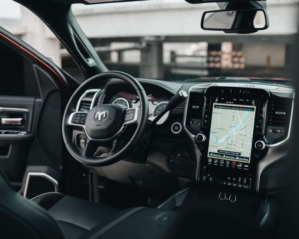 Front seat area of a car with a car services app connected.