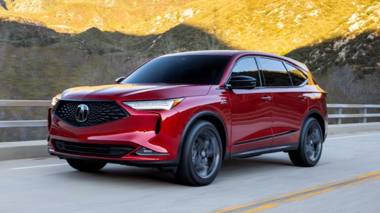 Red Acura MDX on the mountain hill road.