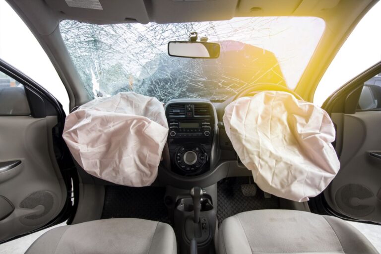 A frontseat airbags with broken windshield.