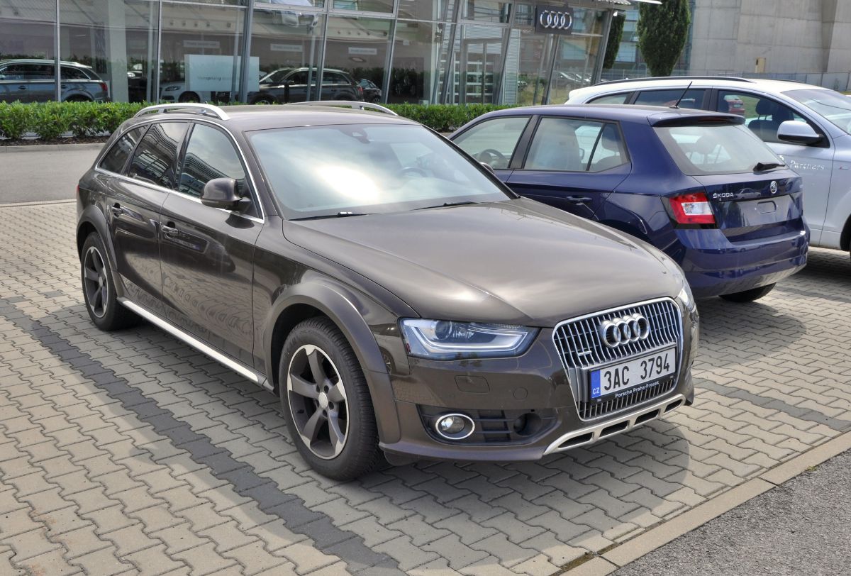 Gray metallic Audi e-Tron on parking space.