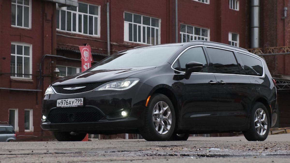 A Chrysler Pacifica Hybrid in all black colorway spotted parked outdoors.