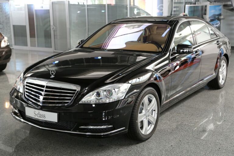 Front view of a shiny black Mercedes S-Class Sedan parked