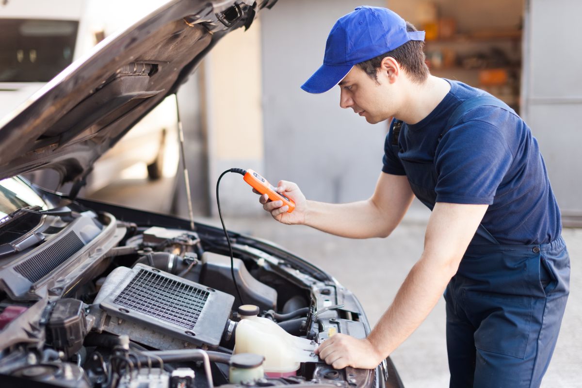 Man tuning-up the car engine.