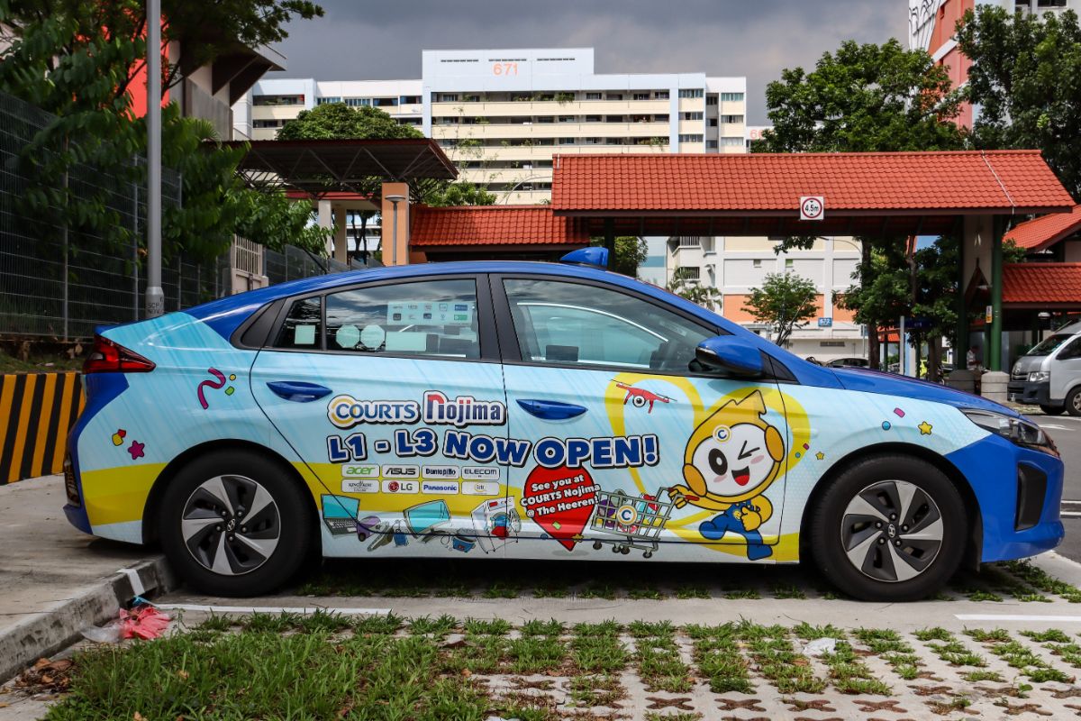 Car on street with car wrapping decal.