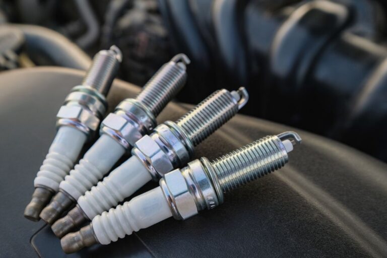 Close up photo of four new spark plug ready to be installed.