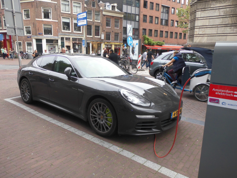 Electric car charging on a street.