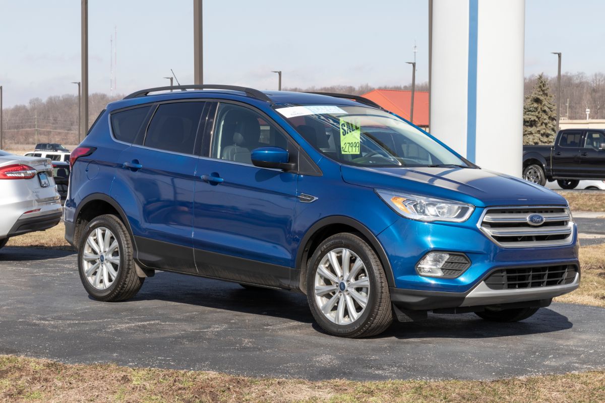 Side view shot of a blue ford car.