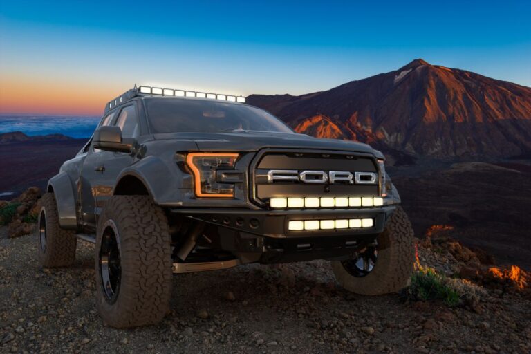 Close up view of a black ford truck with mountain view.