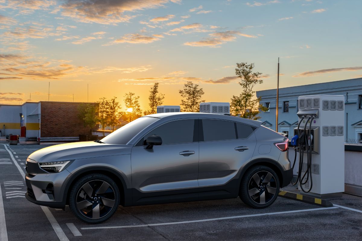 Side view of gray Volvo C40 Recharge charging in an open charging station.