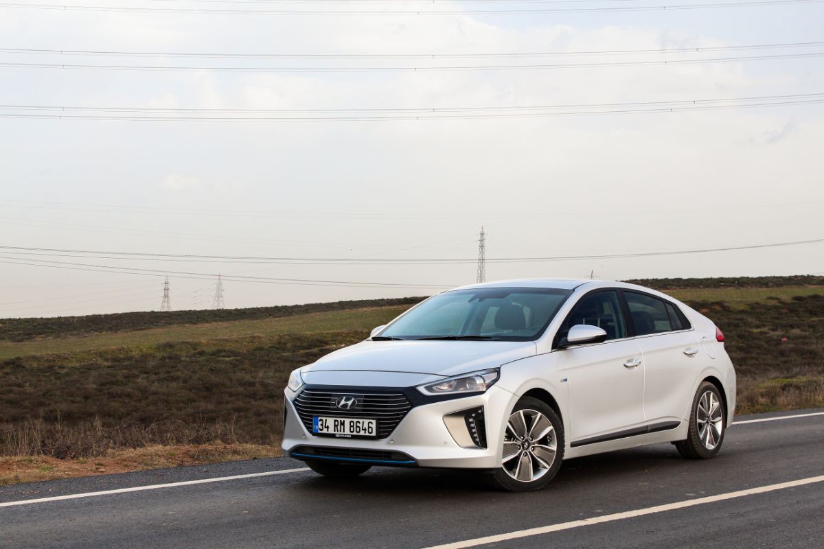 A white dazzling car along the road.