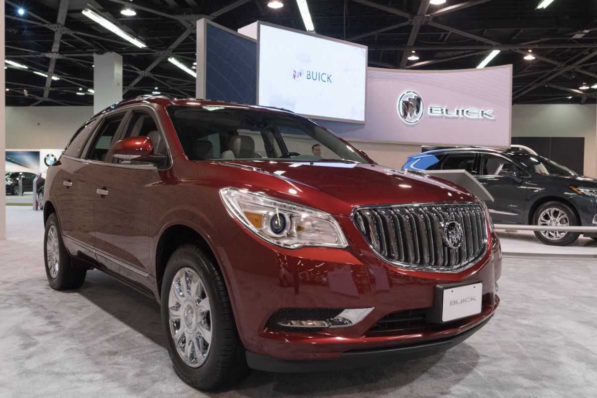 A maroon car's close up front view.