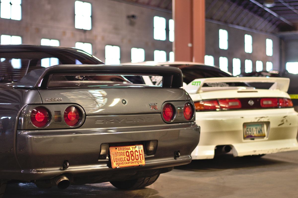 Pedestal spoiler of different cars on car show.