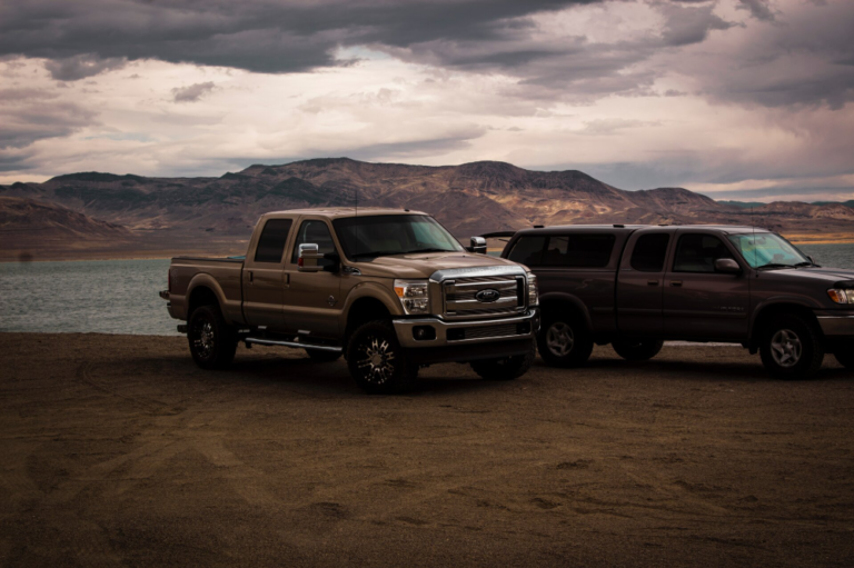 Pickup trucks with mountain range on the background.