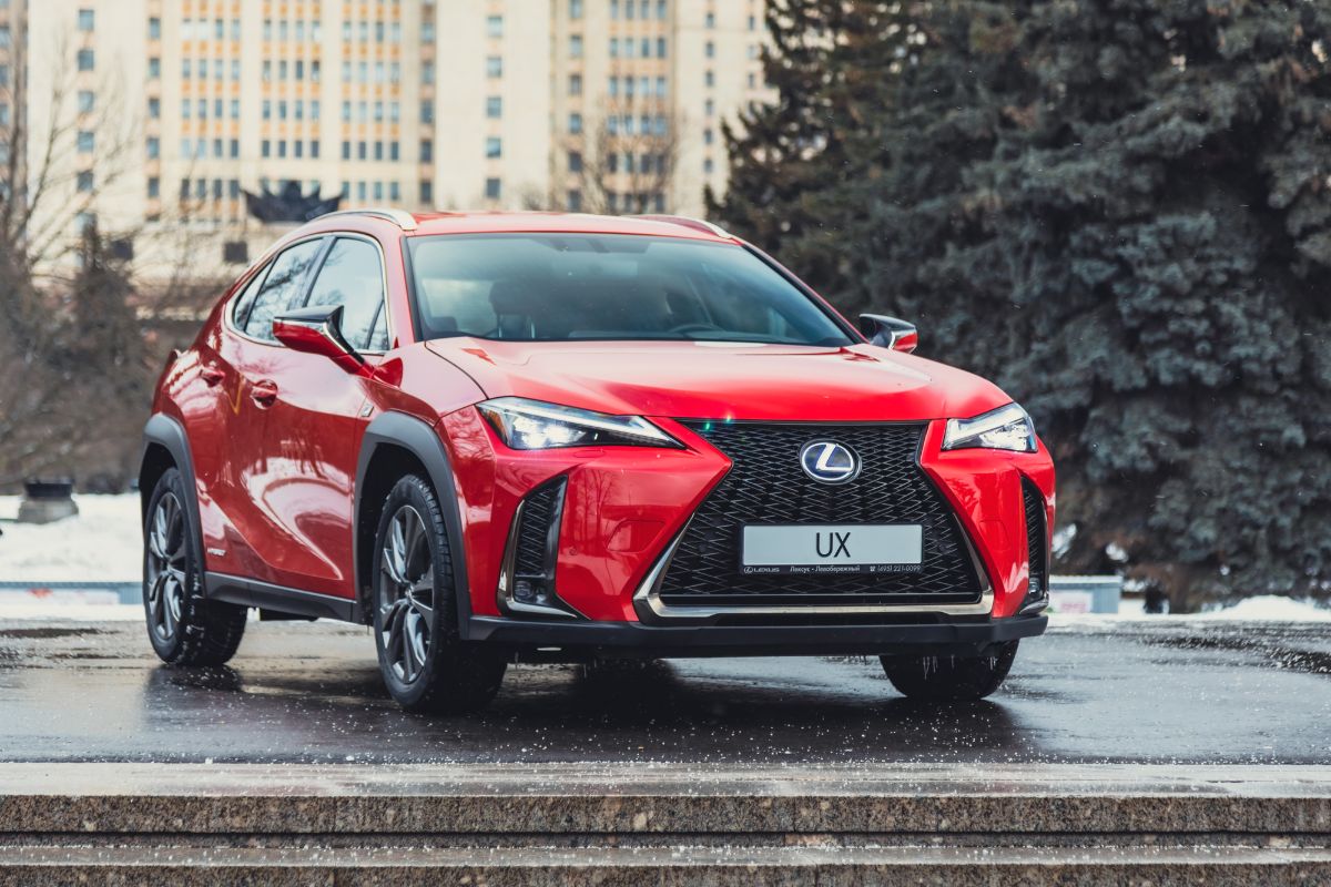 Red Lexus UX 200 Luxury car on wet surface area.