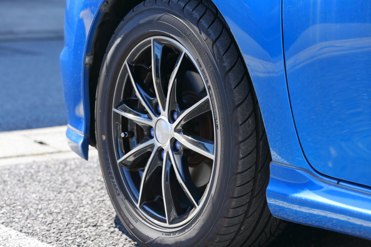 Summer type of tire on blue car.