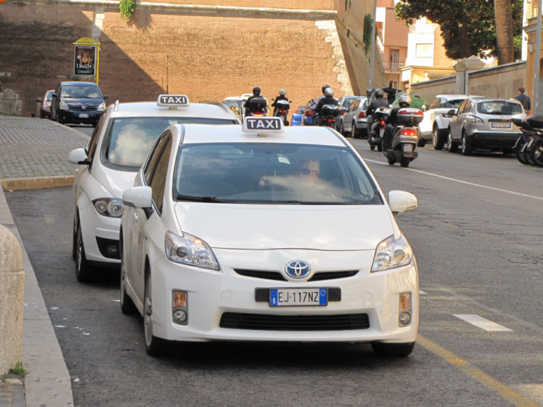 Toyota taxis parked on the side of the road.