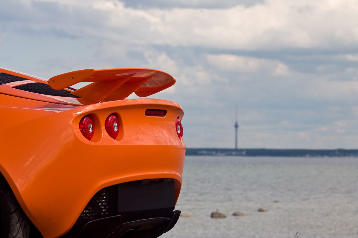 Whale sopiler in an orange Lotus Exige S Rear sport car.