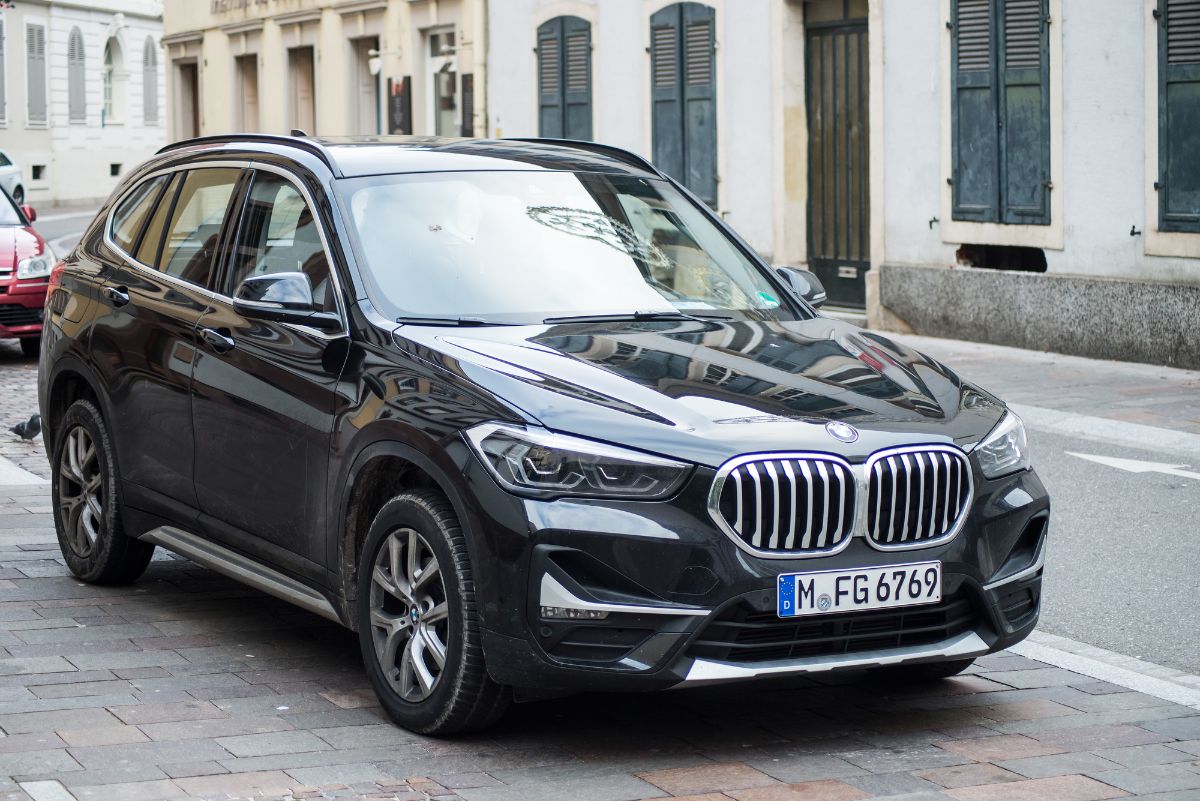 Front view of black BMW X1 on road.