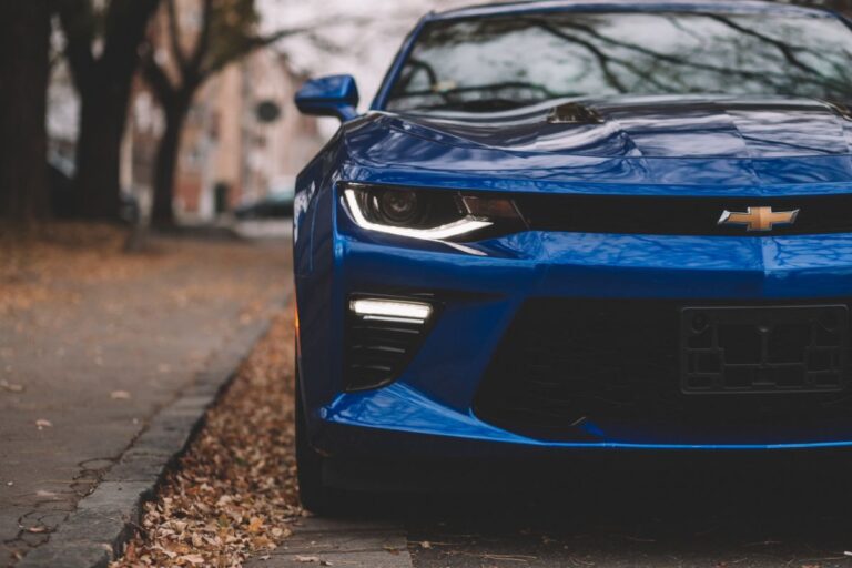 Close up view of blue chevy camaro at the side of road.