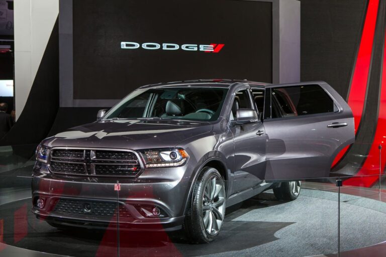 A photo of dodge durango opened backseat door in a show.