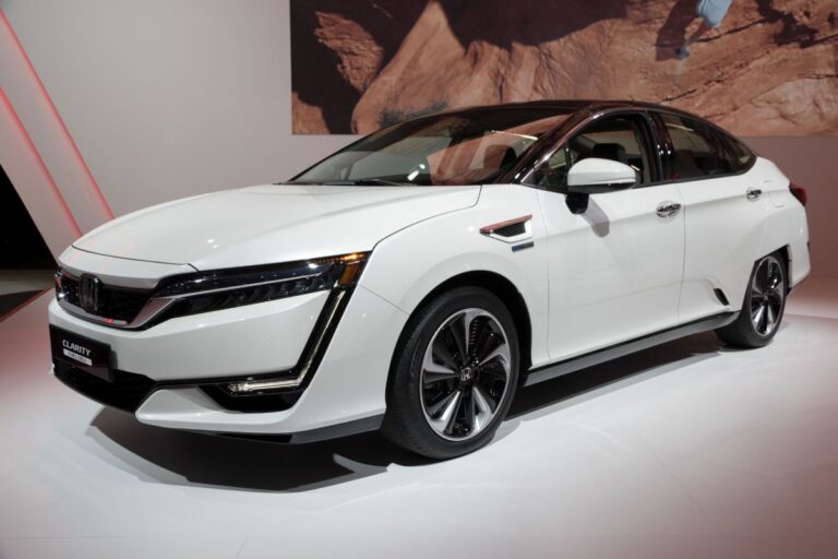 A white honda clarity in a car show.