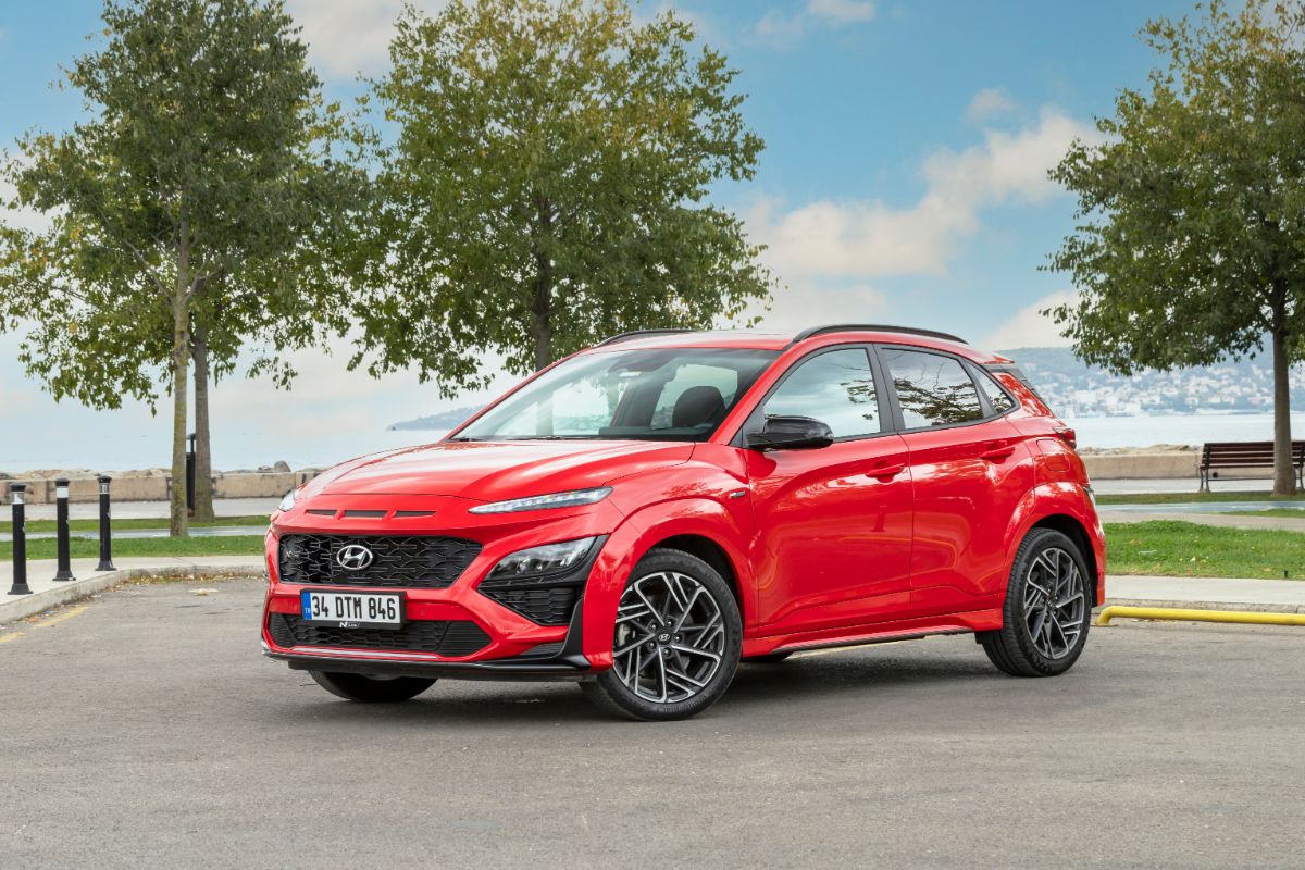 A 3d photo of red hyundai kona n in the park.