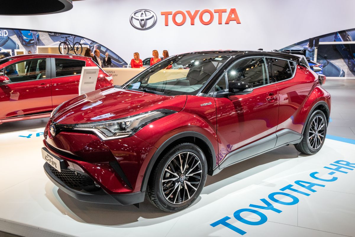 Side view of red Toyota C-HR on car show.