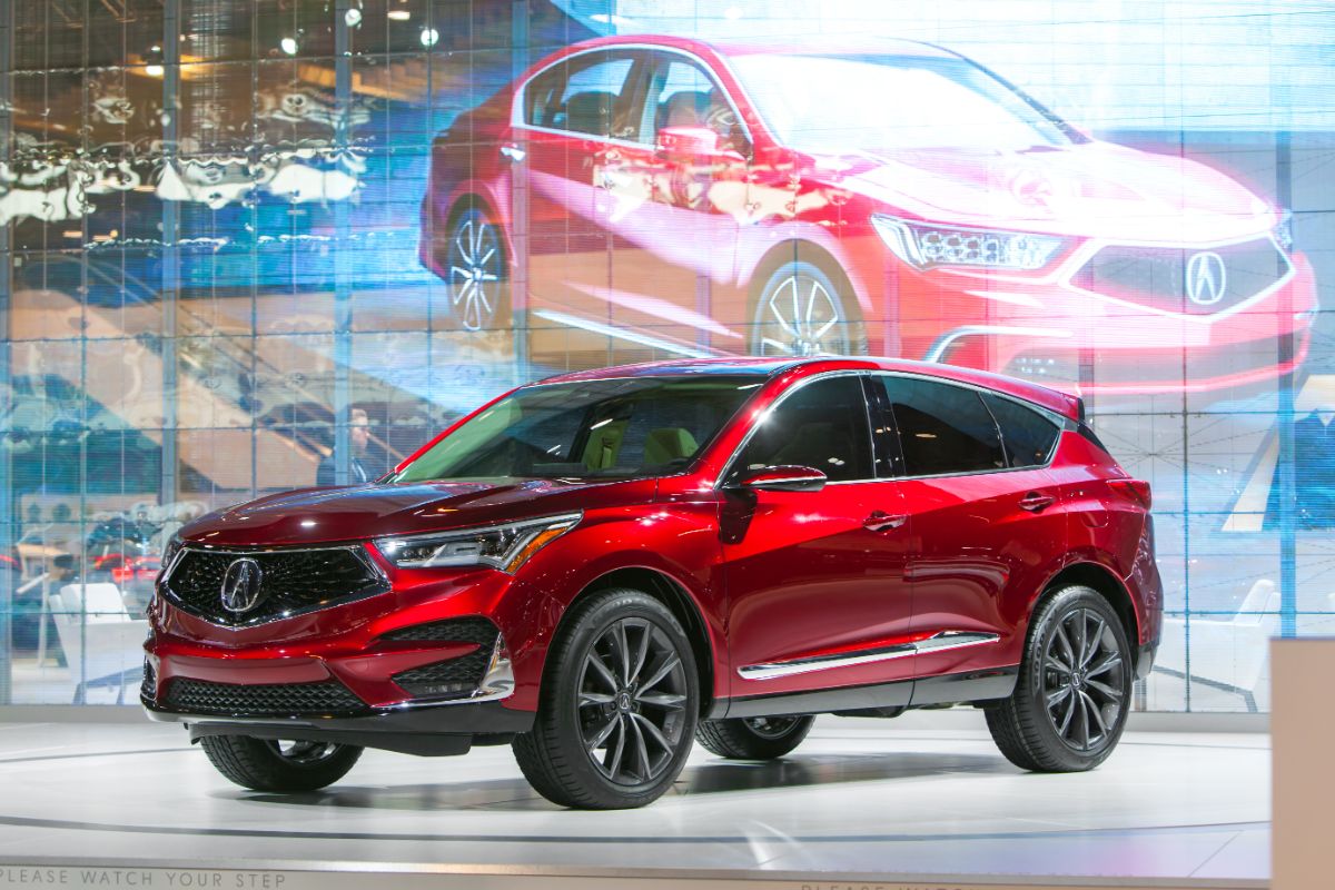 A side view of a red Acura RDX Sport on car show.