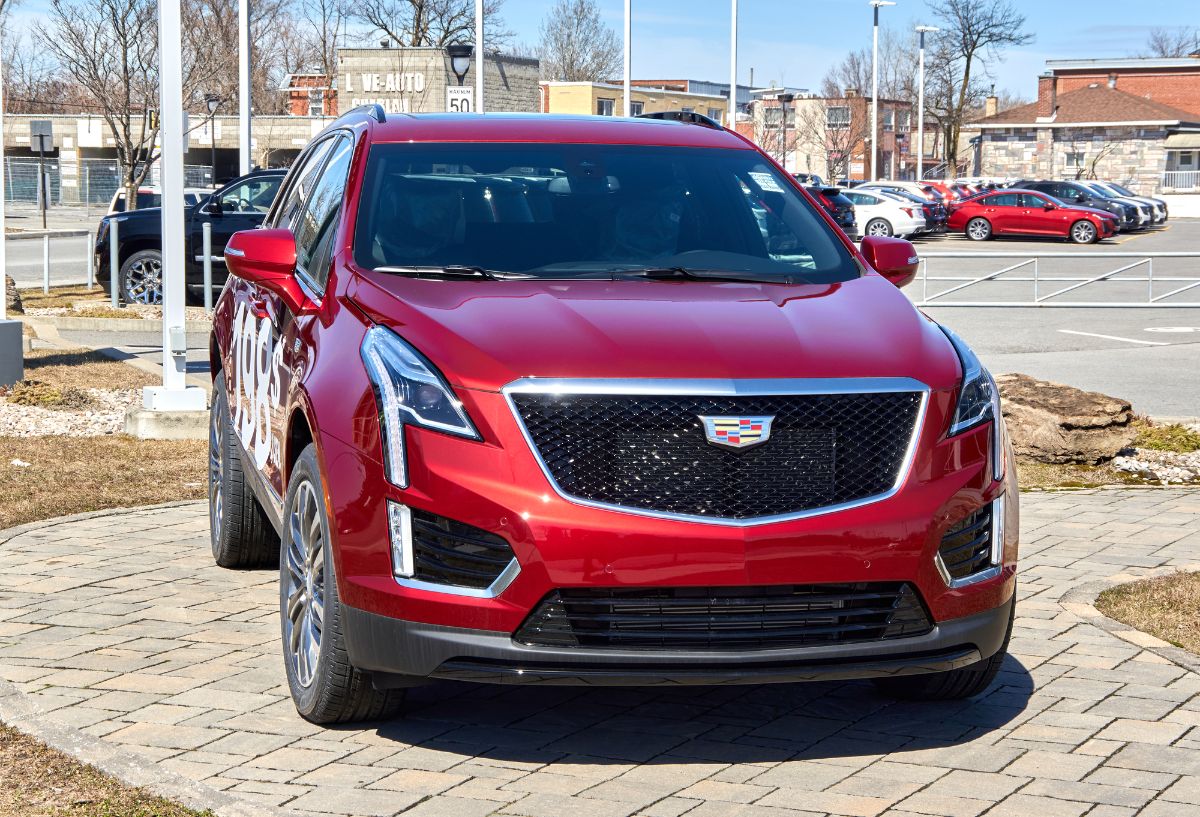 Front view of red Cadillac XT5 in parking space.