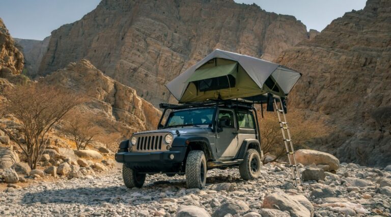 A suv camping on desert place with tent.