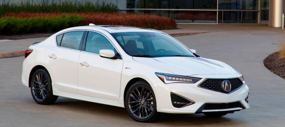 Side view of white 2022 Acura ILX on road.